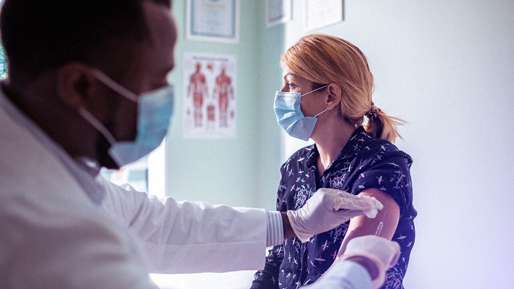 doctor vaccinating a patient in health care facility