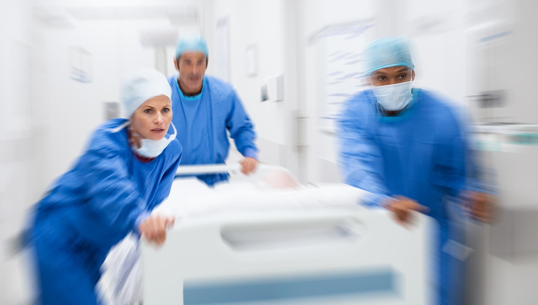 medical staff running with a stretcher